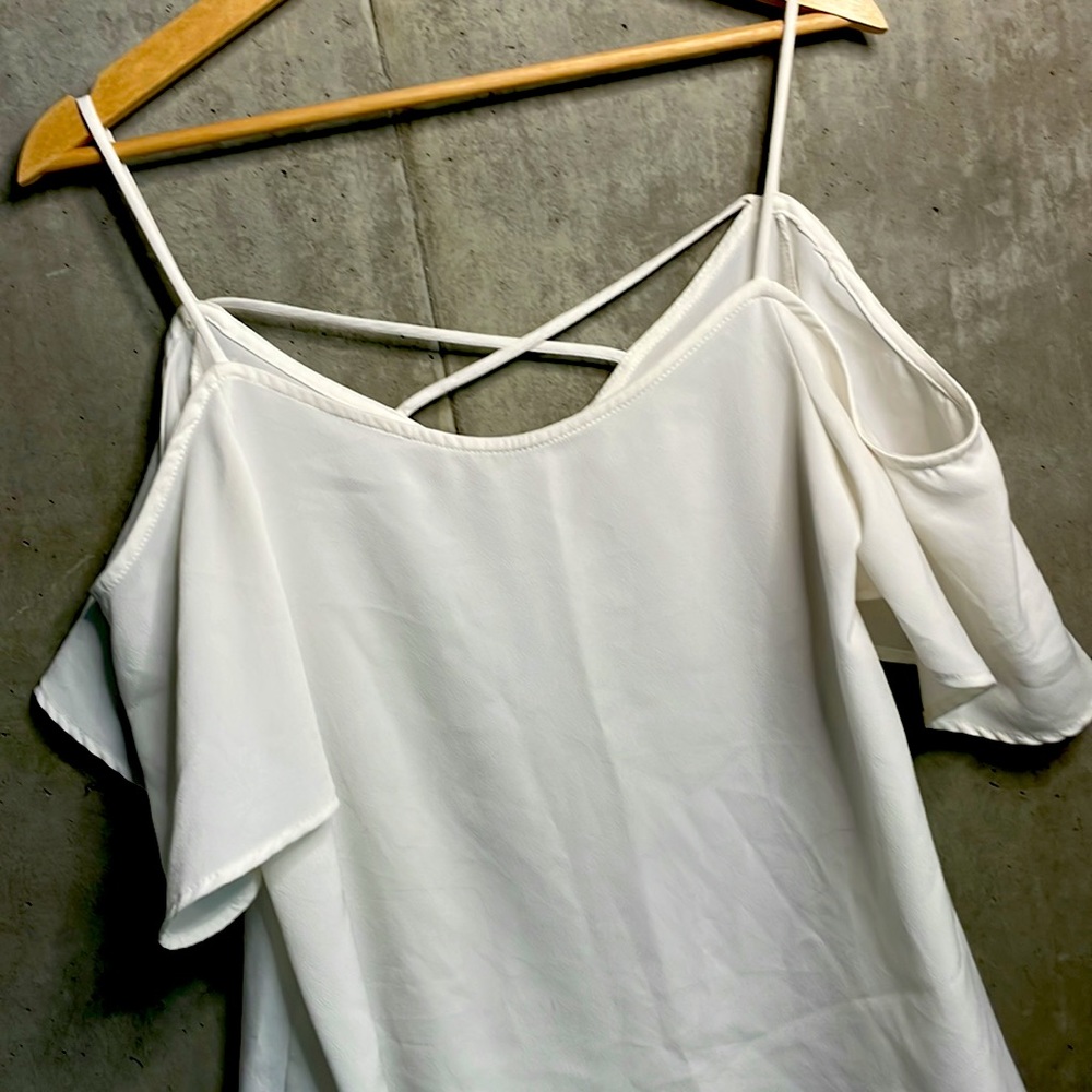 Flowy white blouse with peekaboo shoulder
